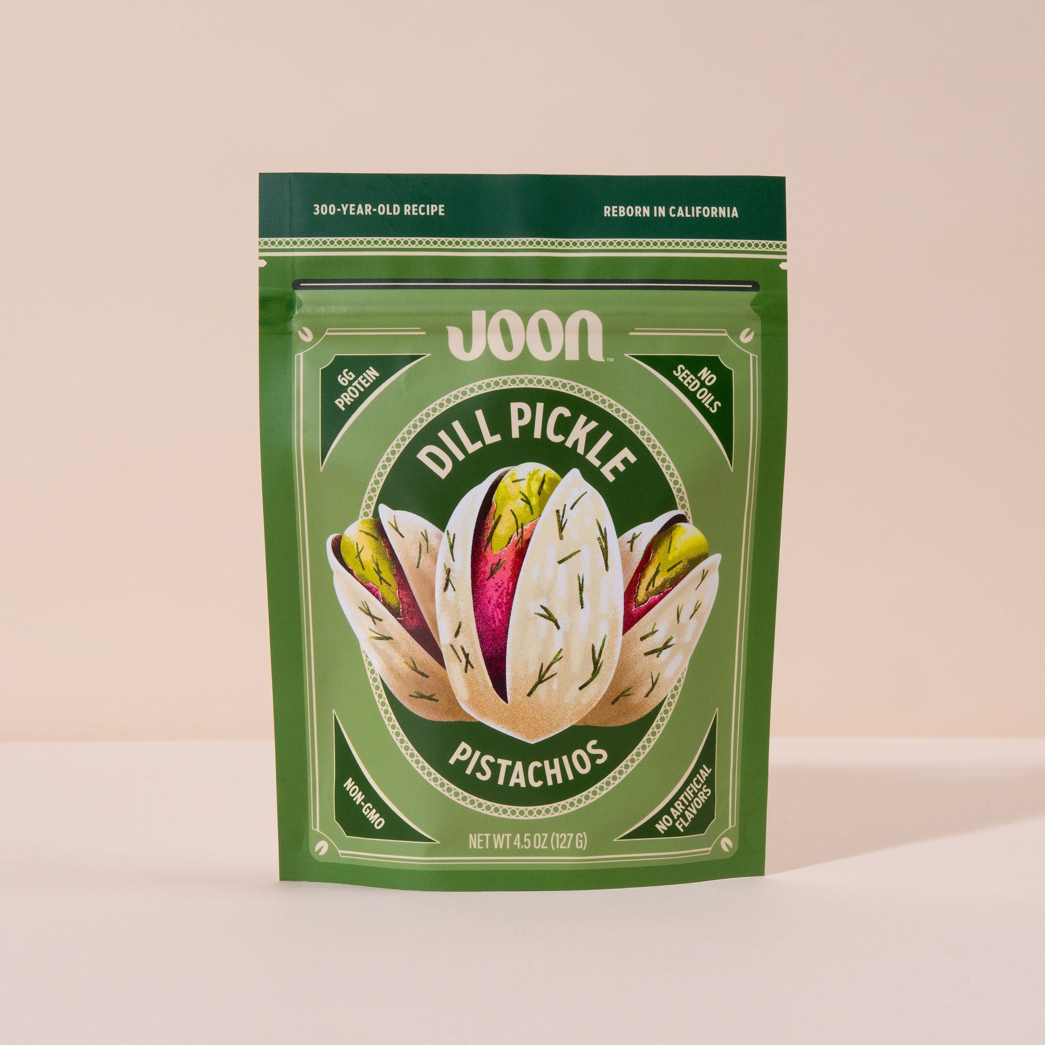 A package of Joon Dill Pickle Pistachios with a graphic of pistachios on the front.