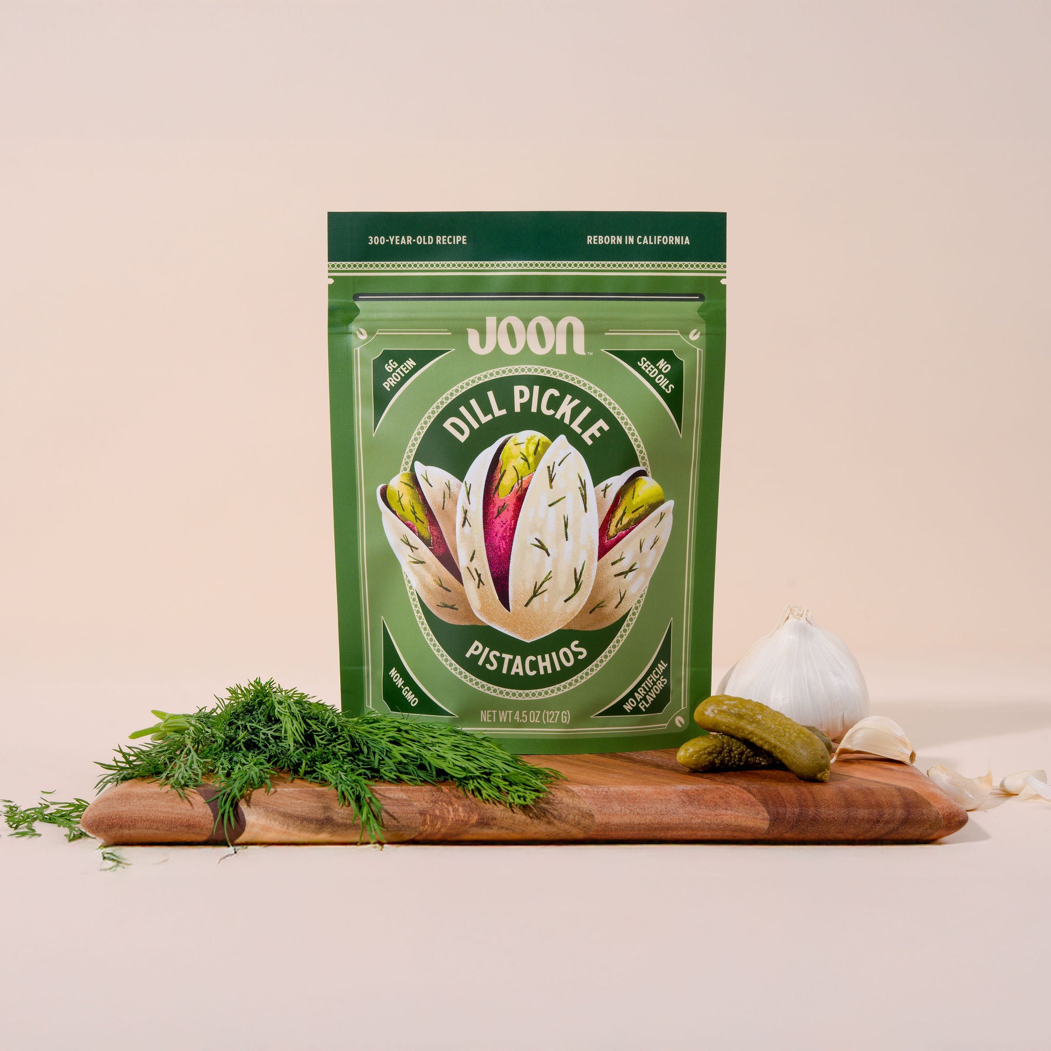 Joon Dill Pickle Pistachios in resealable bag on cutting board with ingredients 